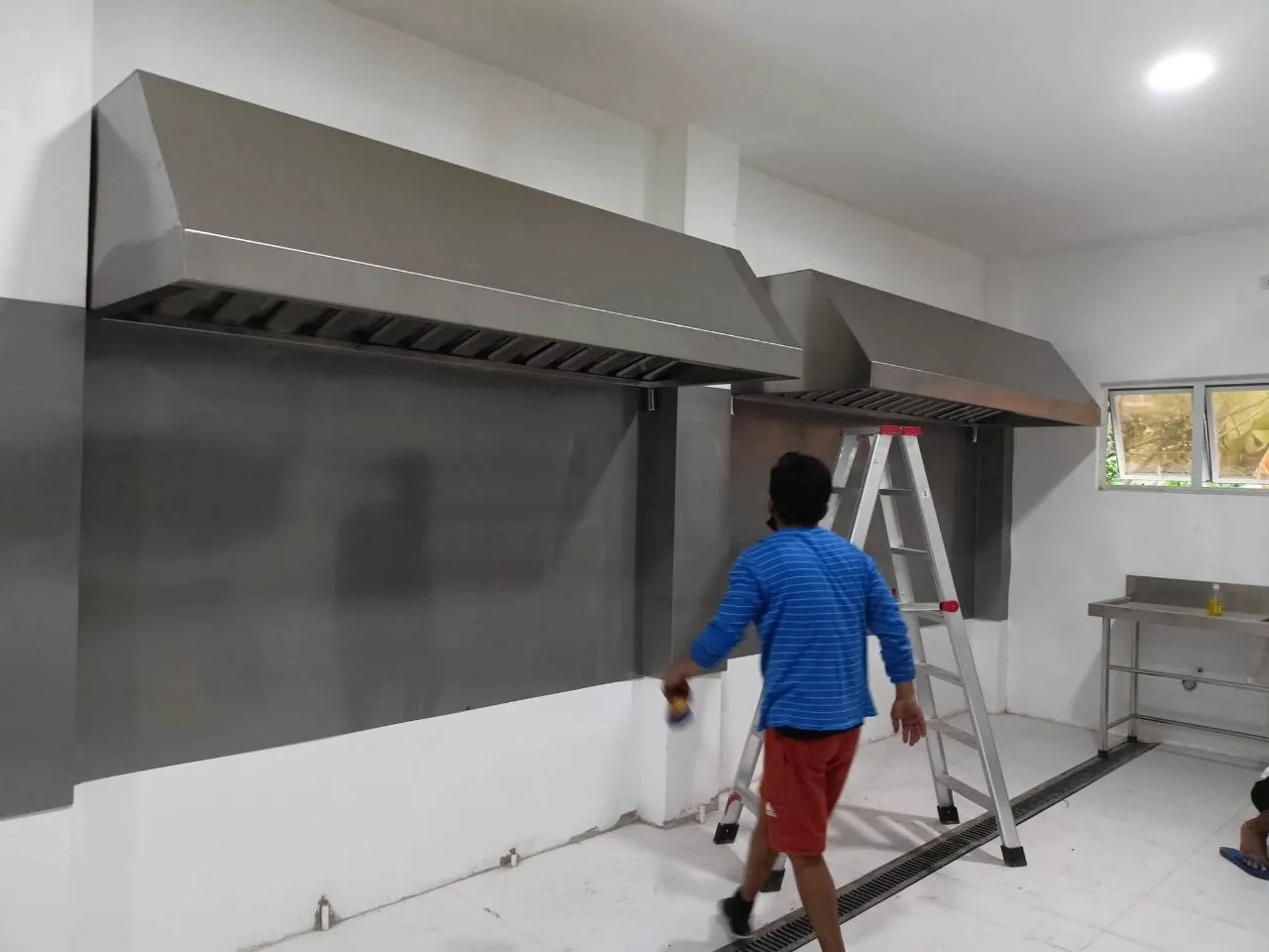 Stainless-steel commercial kitchen exhaust hoods at Aling Lucing Sisig Commissary